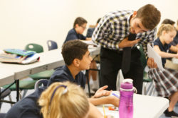 A student asks a question of an instructor one on one