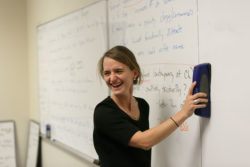 An instructor erasing a board