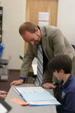 An instructor going over schoolwork