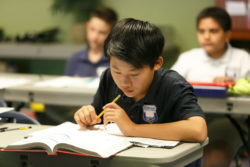 A student searching a schoolbook