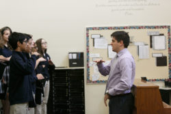 An instructor helps students level their notes
