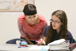 A student asks a one on one question of the instructor