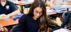 girl looking down at desk
