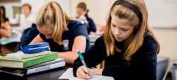 girl students writing in class