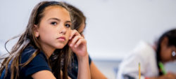 girl looking off into distance during class