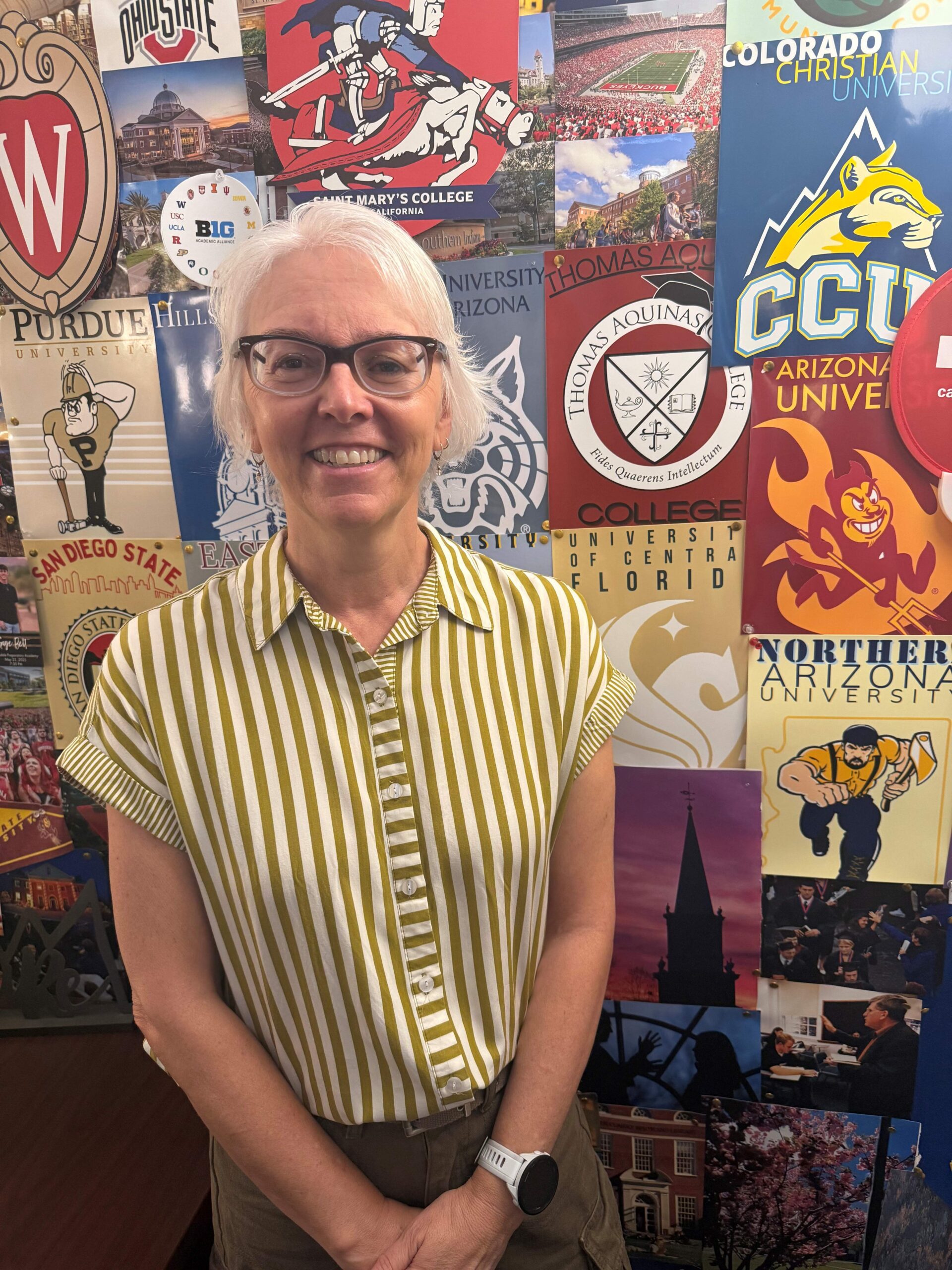 woman standing in front of college posters